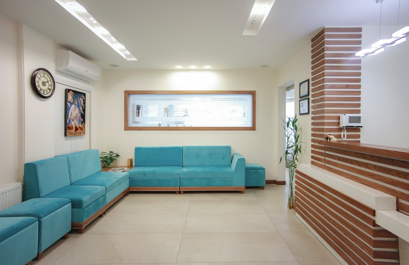 An empty dental waiting room with an unattended reception desk